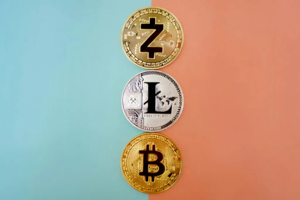 Gold or Silver metapor with Colorful display of Zcash, Litecoin, and Bitcoin coins on gradient background.